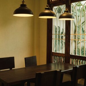 Elegant dining area in Dalat, Vietnam featuring wood table, chairs, and pendant lights.